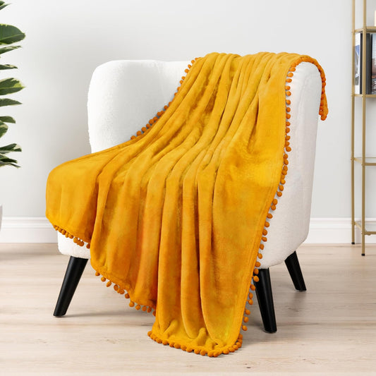PAVILIA Fleece Throw Blanket for Couch with Pom Pom Fringe, Mustard Yellow, Soft Cozy Fuzzy Flannel Blanket for Sofa Bed, Lightweight Plush All Season Throw, 50x60 Inches