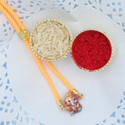 Rakhi Gift Box | Devine Rakhi Hamper with Delightfuly Cute Ganeshji Rakhi Bracelet, Roli, Chawal, Mini Thali Set, A Chocolate, And A Greeting Card (Yellow Ganeshji Gift Box)